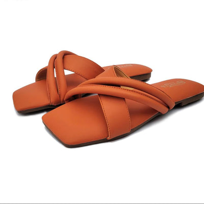 Pair of orange sandals with交叉straps on a white background, featuring the Steplia brand.
